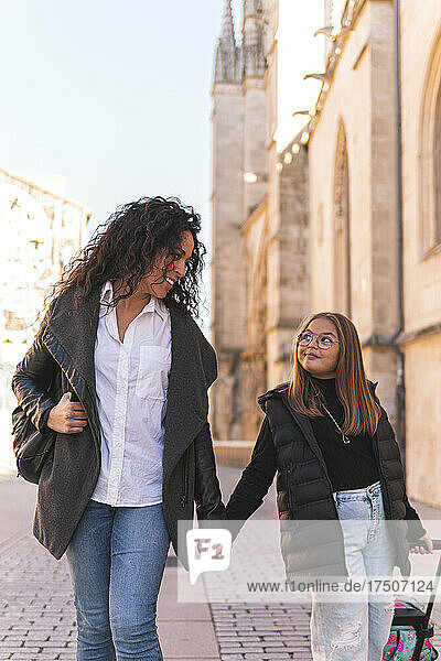 Mother and daughter walking by Burgos Cathedral  Burgos  Spain