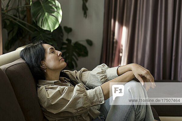 Woman resting on sofa at home