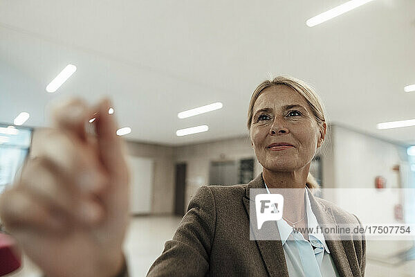 Smiling blond businesswoman at office