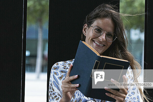Beautiful businesswoman holding book