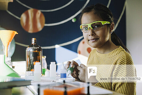 Porträt einer Studentin  die ein wissenschaftliches Projekt zu Hause durchführt