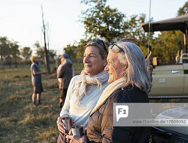 senior woman and adult daughter on safari  Okavango Delta  Botswana