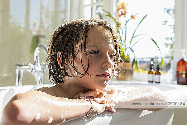 Eight year old boy in a bathtub  having a bath