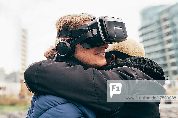 Italy  Couple withVRgoggles hugging in city