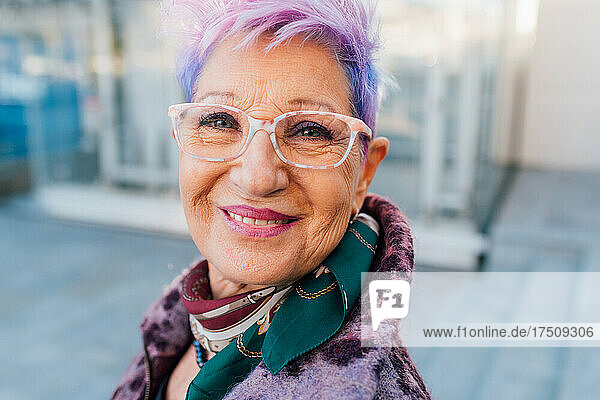 Italy  Portrait of fashionable senior woman with purple hair