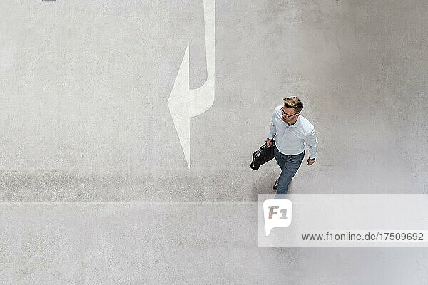 High angle view of businessman walking in city
