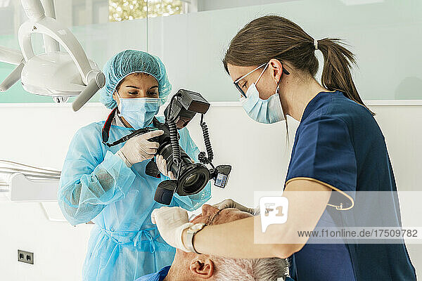 Female doctor and nurse with patient in dentist's clinic