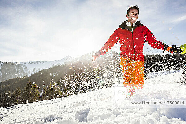 Carefree couple running through the snow  Achenkirch  Austria