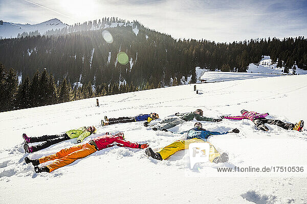 Group of friends lying in snow  Achenkirch  Austria
