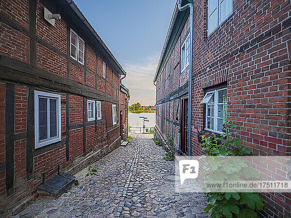 Germany  Schleswig-Holstein  Lauenburg  Cobblestone alley between brick houses