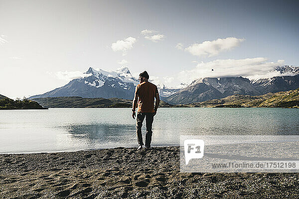 Man walking by lake Pehoe in Torres Del Paine National Park Patagonia  South America