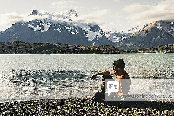 Man sitting by lake Pehoe in Torres Del Paine National Park  Chile Patagonia  South America
