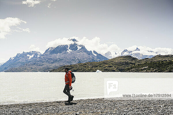 Man walking by lakeshore at Torres Del Paine National Park  Chile  Patagonia  South America