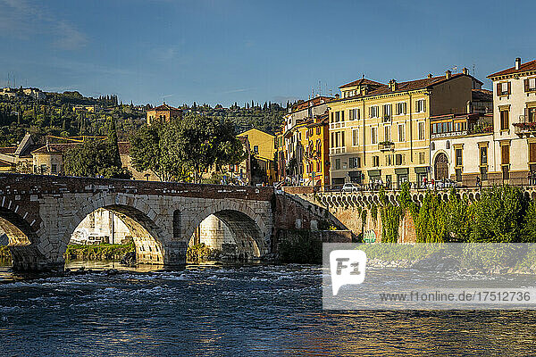 Italy  Veneto  Verona  Arch bridge over Adige river with city houses in background
