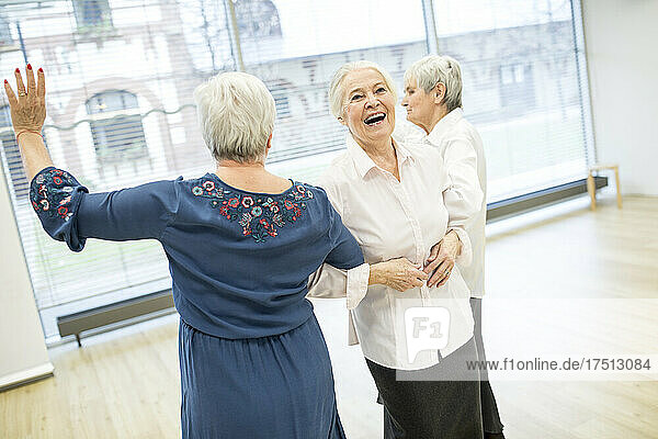 Happy senior women attending dance course in retirement home
