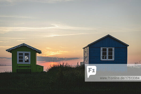 Denmark  Region of Southern Denmark  Aeroskobing  Small coastal bathhouses at sunset