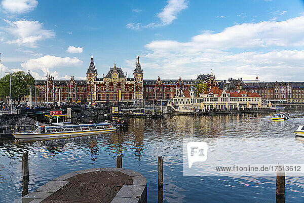 Netherlands  North Holland  Amsterdam  City canal with Amsterdam Centraal Railroad Station in background