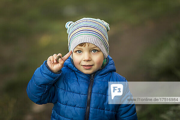 Portrait of blonde little boy with blue eyes and blue jacket sal