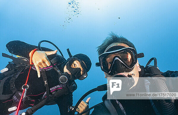 scuba divers taking selfie in the tropical waters around Komodo