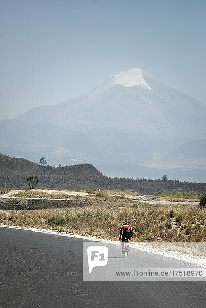 One person road cycling by himself on his way to Pico de Orizaba