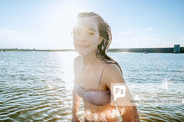 Teen girl playing in lake on a sunny day