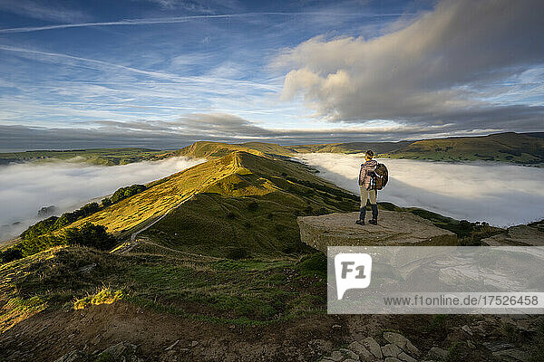 A man looking across The Great Ridge during a cloud inversion with view of Mam Tor  Hope Valley  Peak District  Derbyshire  England  United Kingdom  Europe