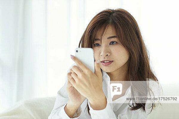 Japanese Woman Looking At Cell Phone
