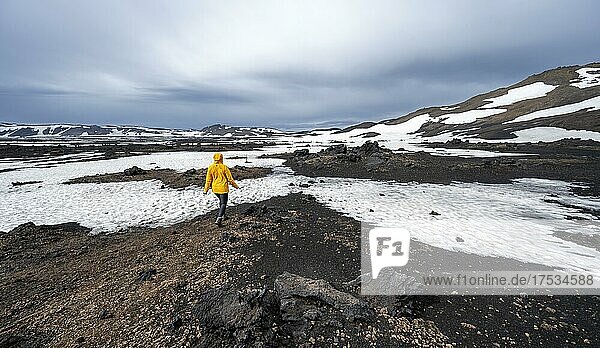 Hiker in the crater of the Askja volcano  snow-covered volcanic landscape  Iceland  Europe