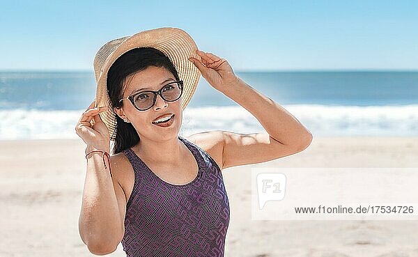 Woman with hat happy on the beach  beach vacation concept