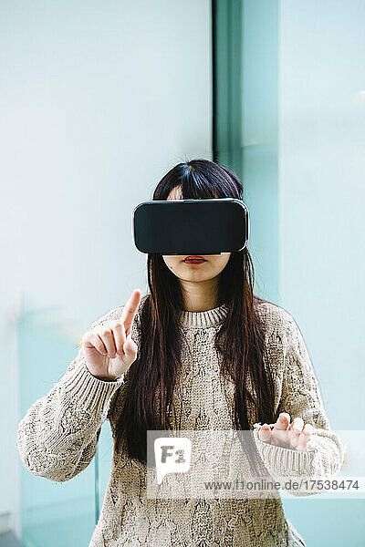 Young woman with long hair wearing virtual reality headset