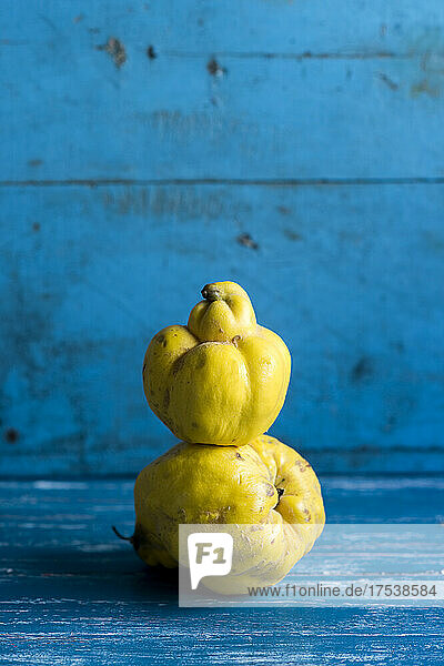 Studio shot of quince lying on top of another quince