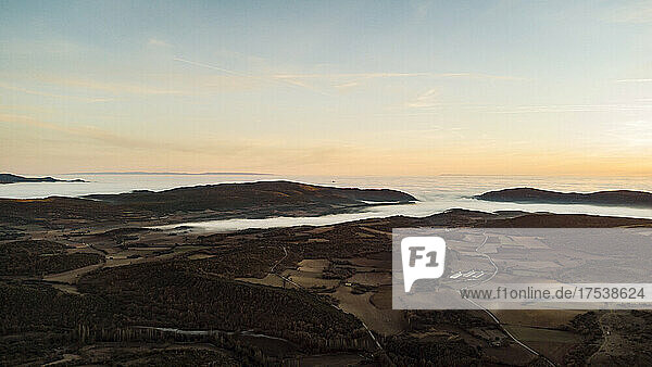 Spain  Province of Huesca  Estopinan del Castillo  Aerial panorama of mountains shrouded in sea of clouds at dusk