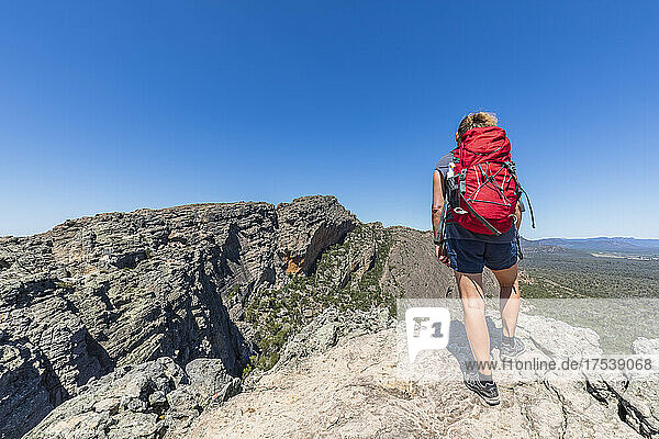 Australia  Victoria  Female tourist admiring view from summit of Hollow Mountain
