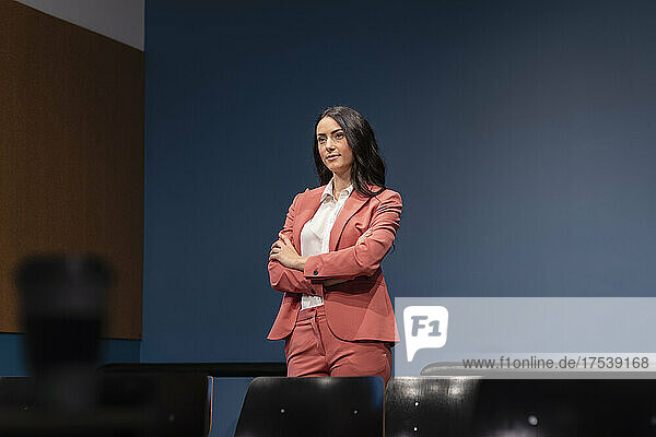 Contemplative businesswoman with arms crossed in office