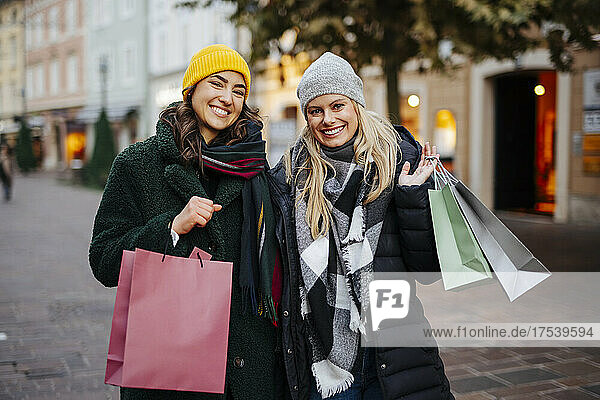 Cheerful women with shopping bags at market