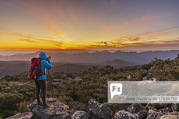 Australia  Victoria  Female tourist taking pictures from Mount William at sunset