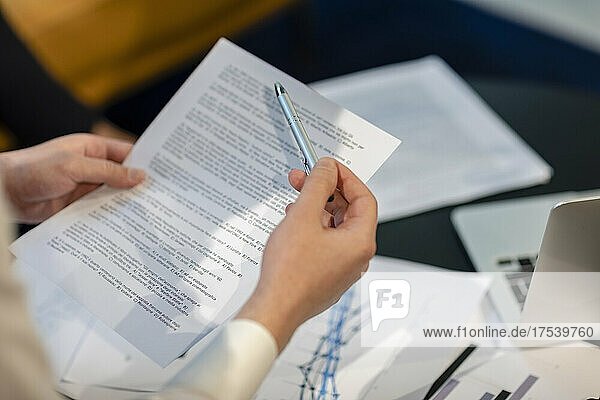 Businessman with pen and document in office