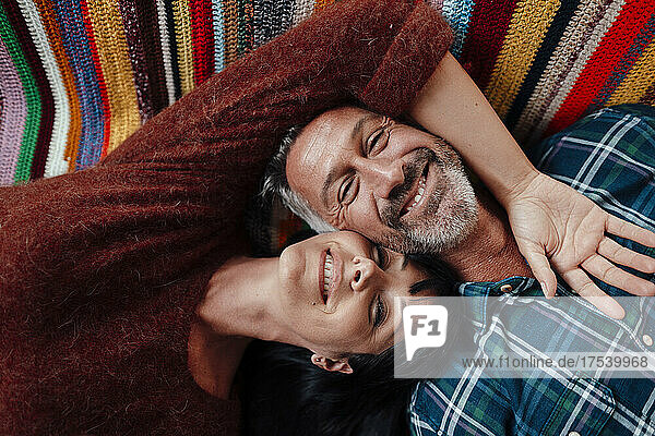 Smiling mature couple resting at home