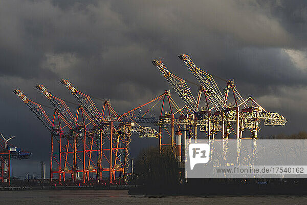 Germany  Hamburg  Storm clouds over cranes in Port of Hamburg