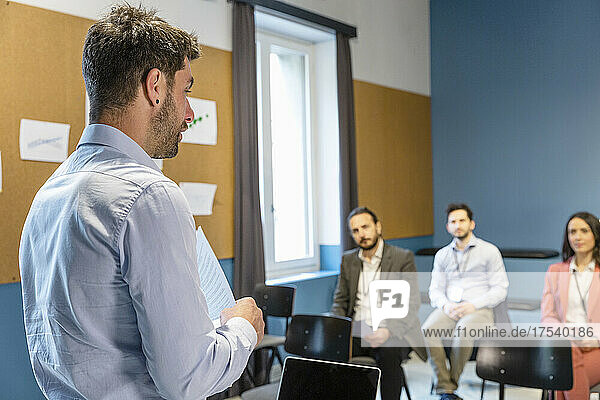 Businessman explaining business strategy to colleagues in office meeting