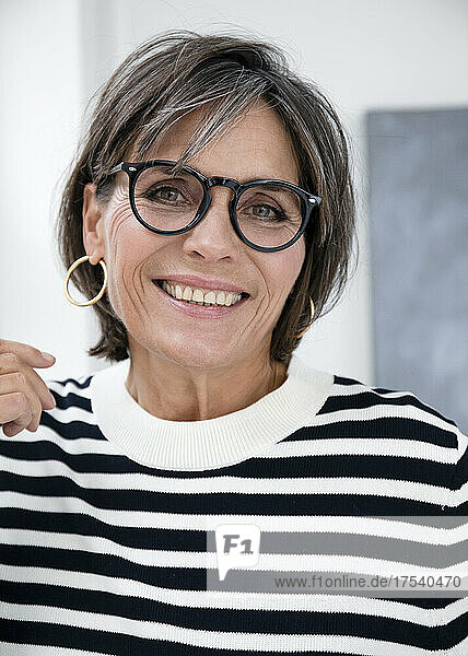 Happy mature businesswoman wearing eyeglasses
