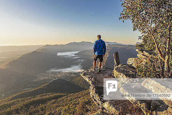 Australia  Victoria  Halls Gap  Male tourist admiring view from Boroka Lookout at dawn