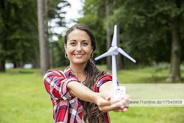 Smiling woman holding wind turbine model at Cannock Chase