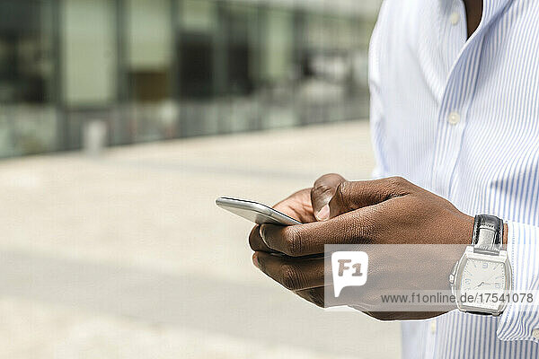 Young man texting on smart phone