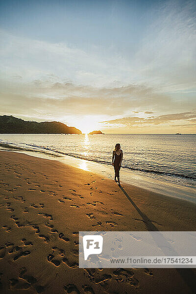 Woman walking at Del Coco beach  Guanacaste Province  Costa Rica