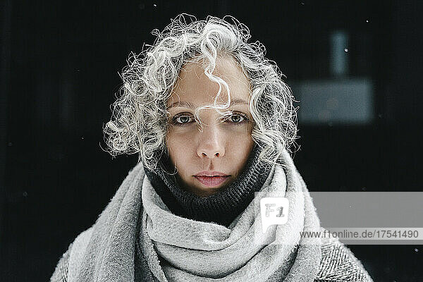 Woman with gray curly hair wrapped in gray scarf