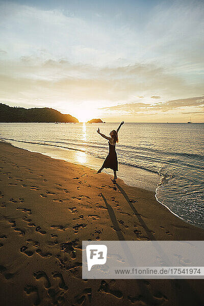 Woman enjoying sunset dance at Del Coco beach  Guanacaste Province  Costa Rica