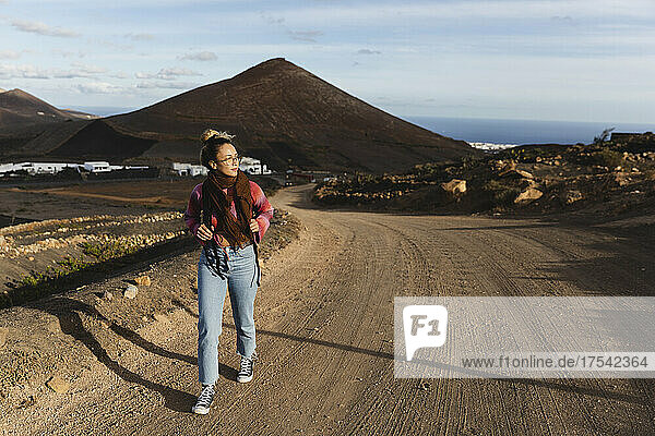 Young woman walking on dirt road