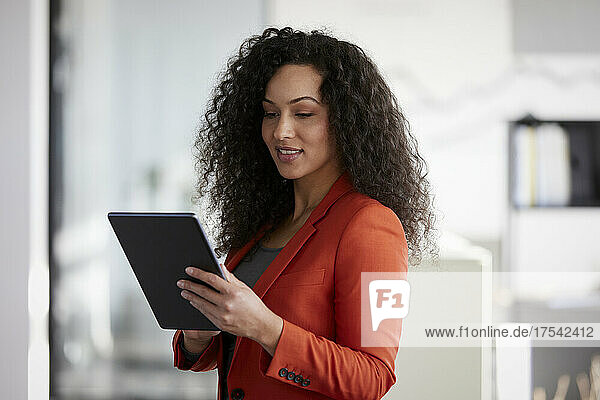 Businesswoman using tablet PC at workplace