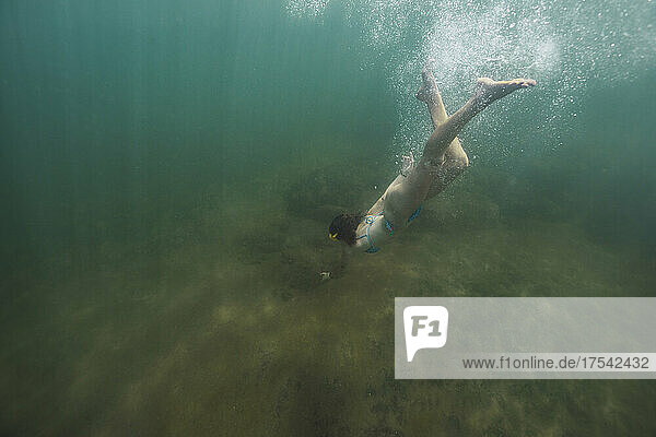 Woman swimming undersea on vacation